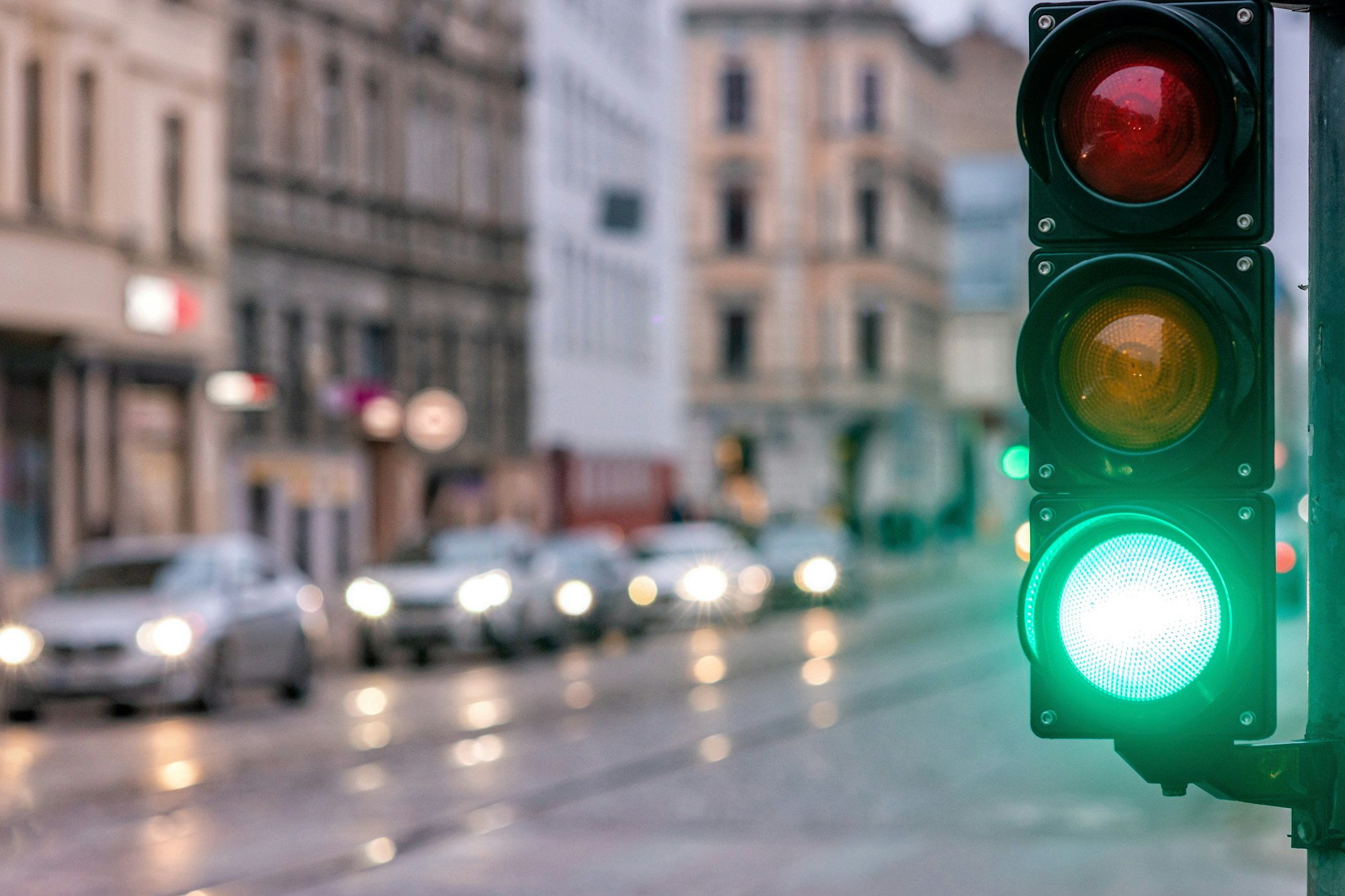 A city crossing with a semaphore, green light in semaphore