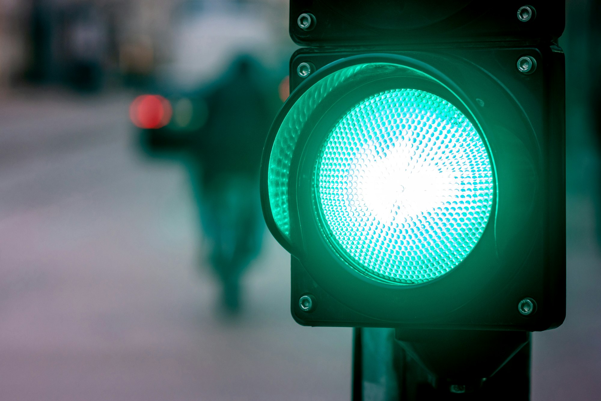 A city crossing with a semaphore, green light in semaphore